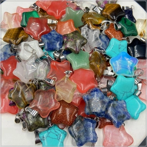 Detailed view of assorted star-shaped natural stone pendants with silver metal bails