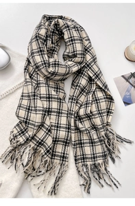 Detailed view of classic black and white plaid scarf with long fringe tassels