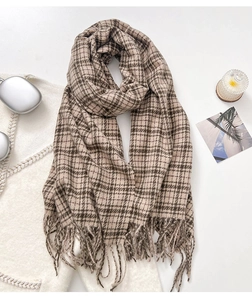 Detailed view of the soft khaki checkered scarf with tassels and trendy lifestyle accessories