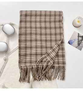 Detail of vintage brown plaid scarf with tassels, thick fabric for winter warmth