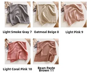 Detailed view of lightweight solid color scarves in five soft pastel tones with raw edges