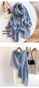 Close-up of soft light blue scarf with fringe detail and autumn fashion accessories