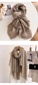 Detail showing high-quality light brown thin shawl with natural fringed edge texture