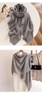 Detail of grey solid scarf with soft tassels and knit texture for sun protection