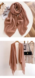 Detail of dusty rose shawl showing delicate tassel fringe edges and soft drape texture