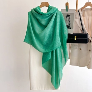 Lightweight grass green linen shawl with delicate fringe, stylish sun protection wrap