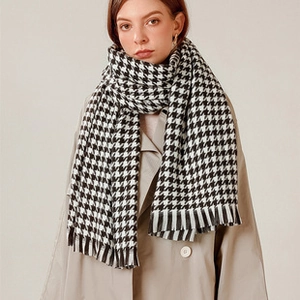 Close-up of black and white houndstooth scarf with elegant tassel edge detail