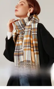 Detailed view of the soft plaid cashmere scarf texture with classic fringe details