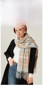 Close-up of soft cashmere-feel plaid scarf with fringe details in classic British style