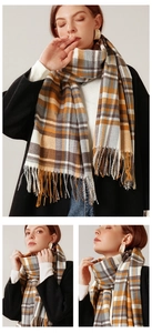 Close-up of ginger plaid scarf texture with soft fringed edges for autumn winter