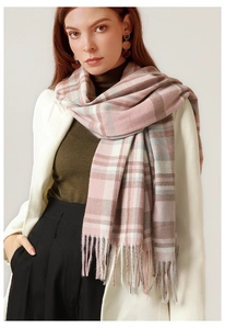 Detail of pink and gray checkered cashmere scarf with elegant tassel edges on model
