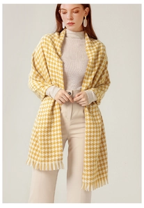 Detailed view of yellow and white houndstooth scarf featuring delicate tassel fringes