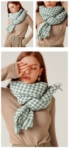 Detail of soft houndstooth scarf showing thick texture and elegant fringe tassels