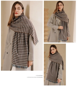 Detail of winter houndstooth scarf with tassels in brown and blue cashmere-like fabric