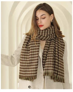 Close-up of military green and coffee plaid scarf with soft fringe on beige coat