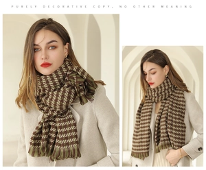 Close-up of thick plaid scarf featuring houndstooth pattern and soft fringe tassels