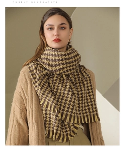Close-up of thick checkered houndstooth scarf with tassels in brown and yellow tones