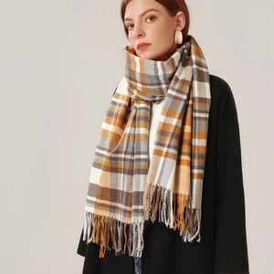 Classic plaid scarf in orange and grey cashmere-like knit with tassels on black coat