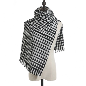 Classic black and white houndstooth scarf with fringe tassel on a white background