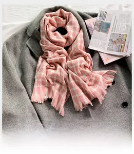 Detail of pink and beige geometric chain pattern scarf with soft fringe tassels