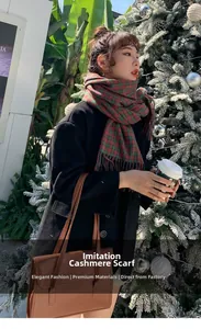 Detail of red and green plaid imitation cashmere scarf paired with a black wool coat