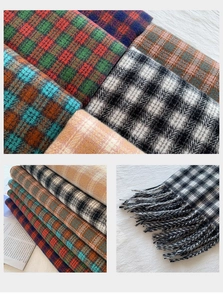 Close-up of thick plaid scarves with soft fringe detail in various winter colors