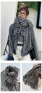 Detail of classic black and white checkered scarf with thick cashmere-like texture and tassels