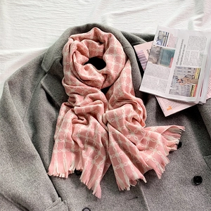 Pink cashmere-feel winter scarf featuring white clover patterns and delicate tassels
