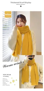Detail of ginger yellow thick knit scarf featuring soft fringe and warm texture