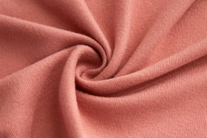 Close-up of soft pink plaid cashmere scarf showing fine knitted texture and fabric detail