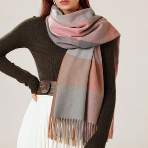 Close-up of cashmere-like shawl with clover tassels and thick warm geometric block pattern