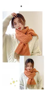 Detail view of thick orange cashmere-feel scarf with wavy texture and fringe trim