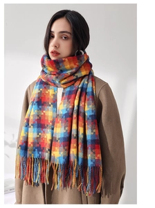 Détail de l'écharpe à carreaux pixel avec de longues franges portée par un mannequin