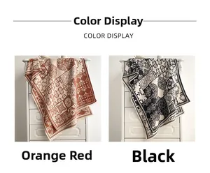 Detail view of ethnic patchwork pattern scarves in orange-red and black color options