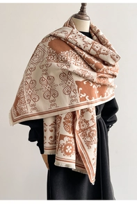 Close-up of dual-tone baroque pattern scarf with fringe edges and premium woven texture