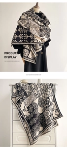 Detail of elegant black and white imitation cashmere scarf with geometric heraldic pattern