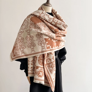 Elegant white and caramel vintage pattern shawl with fringe on a black coat model