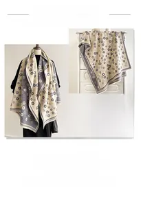 Macro detail of thick floral cashmere-feel scarf with beige and grey pattern weave