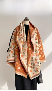 Detail of floral jacquard patterns and tassel edges on thick double-sided cashmere scarf