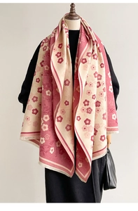 Detail of floral jacquard scarf with double-sided color design and tassel edge