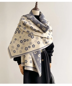 Close-up of double-sided floral cashmere scarf with delicate short fringe detail