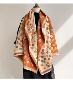 Close-up of double-sided jacquard floral scarf with orange and grey floral patterns