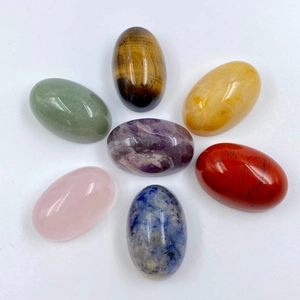 Polished 7 chakra natural stones set including amethyst and rose quartz in a circular layout