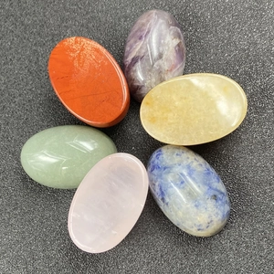 Polished chakra stones set including Amethyst and Rose Quartz for healing and meditation
