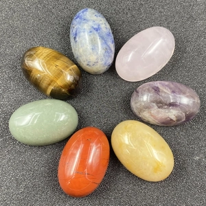 Polished natural chakra stones set including amethyst and tiger eye for meditation