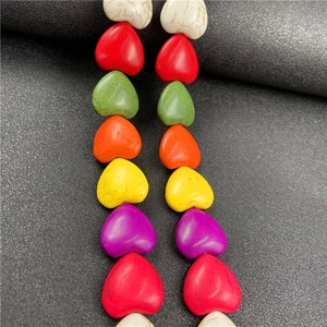 Detailed view of colorful heart-shaped stone beads with marble texture for DIY jewelry