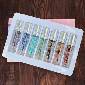Set of 7 glass essential oil roller bottles filled with natural healing crystal stones