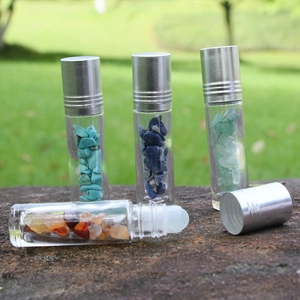Crystal infused glass essential oil roller bottle with silver cap and assorted stones