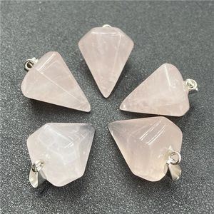 Macro detail of five hexagonal pink quartz crystal pendants with silver metal clasps