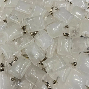Close-up of bulk rectangular translucent white crystal pendants with silver bails